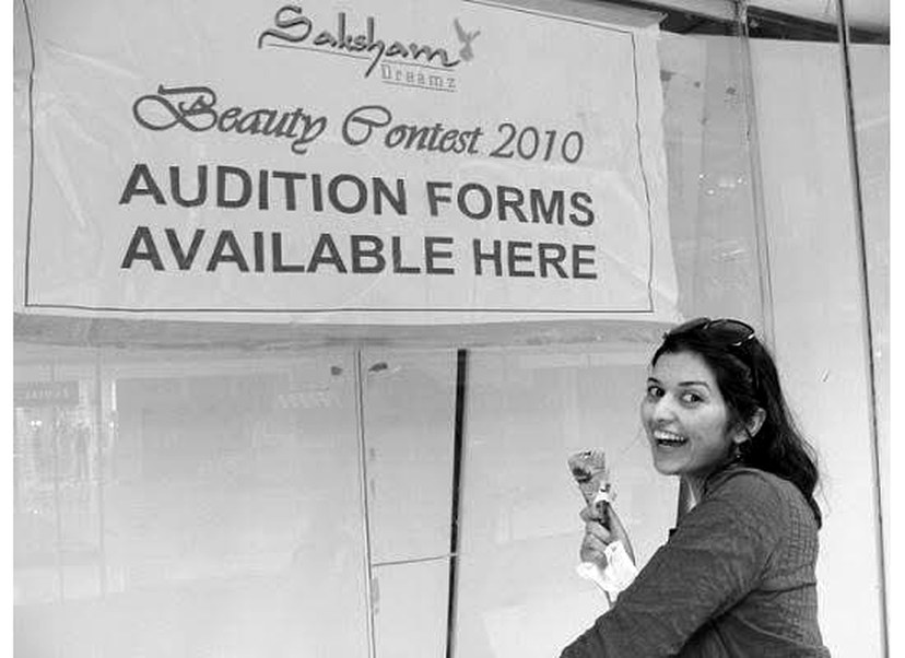Ahmedabad, 2010. Pree with an ice cream cone in front of a beauty contest audition sign.